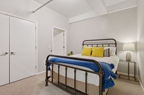 St. Paul apartment for rent - A bedroom with a bed, pillows, and a nightstand.