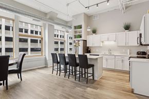 St. Paul apartment for rent - A kitchen with white cabinets and a wooden floor.