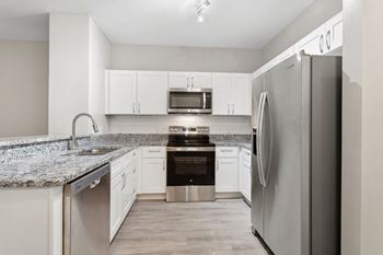 Sleek white custom cabinetry with nickel finishes*