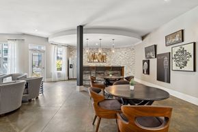 Atlanta apartment for rent - A modern dining room with a stone wall and wooden chairs.