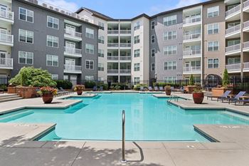 Swimming pool with sun deck & poolside lounging