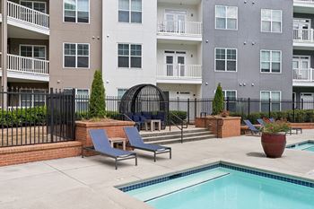 Swimming pool with sun deck & poolside lounging