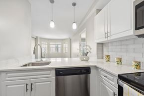 Quincy apartment for rent - kitchen with designer pendant lighting and custom cabinetry at HighPoint luxury apartments