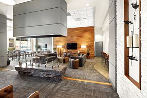 Denver apartment for rent - A modern office space with a stone feature in the middle of the room.