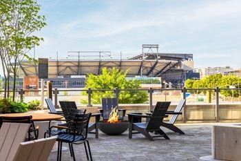 Four breathtaking landscaped courtyards outfitted with fire pits, grill stations, outdoor dining, sun lawn, bocce field, with river and city views