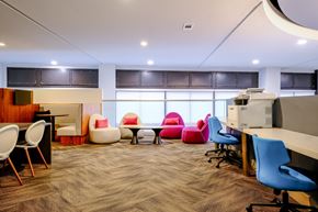 Chapel Hill apartment for rent - A modern office space with a variety of seating options and a carpeted floor.