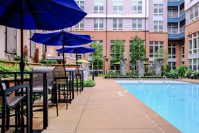 Chapel Hill apartment for rent - A pool area with chairs and umbrellas.