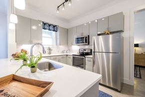 Rowlett apartment for rent - modern kitchen with stainless steel appliances at Reveal on the Lake luxury apartments