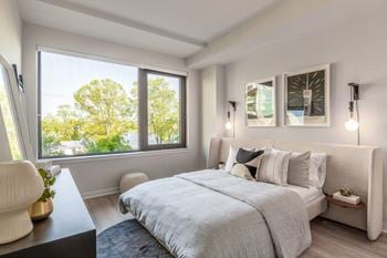 Expansive windows allowing an abundance of natural light with custom roller shades for privacy