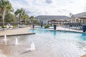 Magnolia apartment for rent - A pool with water fountains in the middle of it.