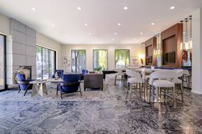 Phoenix apartment for rent - A modern dining room with a marble floor and a long table set for a meal.