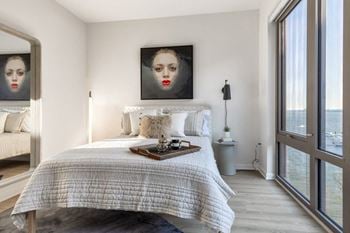 Expansive windows allowing an abundance of natural light with custom roller shades for privacy
