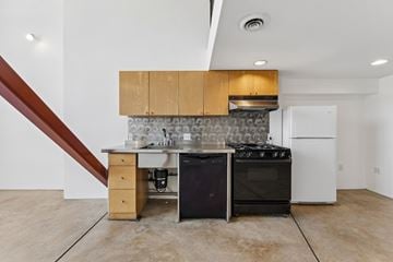 San Francisco apartment for rent - A kitchen with a black stove top oven and a white refrigerator.