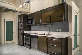 Los Angeles apartment for rent - A modern kitchen with dark wood cabinets and stainless steel appliances.