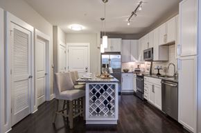 Charlotte apartment for rent - A kitchen with a table and chairs in the middle.
