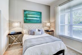 Durham apartment for rent - A bedroom with a large bed and a painting on the wall.