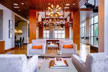 Durham apartment for rent - A living room with a grey couch and a wooden ceiling.