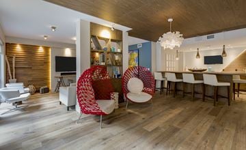 Ft. Lauderdale apartment for rent - A modern living room with a red chair and white chairs.