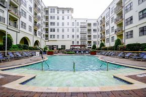Raleigh apartment for rent - A large swimming pool in the middle of a courtyard surrounded by apartment buildings.