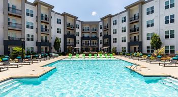 Pool with aqua sunshelf & expansive sundeck with cabanas