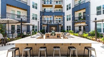 Outdoor kitchen with grills and al fresco dining area
