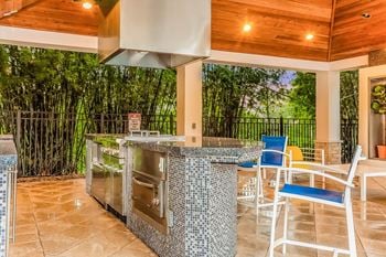 Outdoor lounge kitchen with bbq grills and fireplace