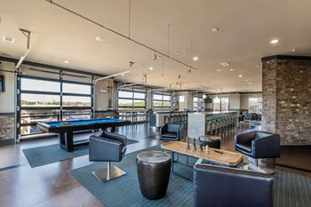 Game room with dartboard, billiards table, shuffleboard, and poker table
