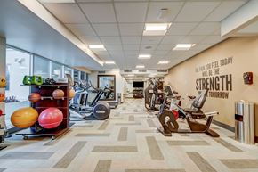 Los Angeles apartment for rent - A gym with a variety of equipment and a motivational quote on the wall.