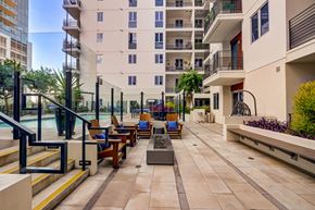 Los Angeles apartment for rent - A patio with a pool and chairs is surrounded by apartment buildings.