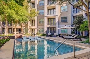 Dallas apartment for rent - A swimming pool in front of a residential building.