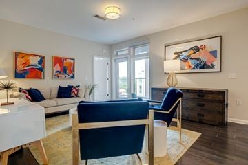 Chapel Hill apartment for rent - A living room with a blue chair and a painting on the wall.