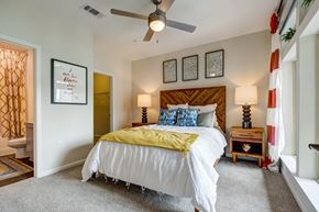 Chapel Hill apartment for rent - A bedroom with a white bed and a yellow blanket.