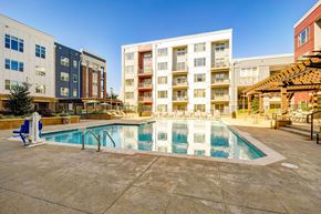 Durham apartment for rent - A large swimming pool in front of apartment buildings.