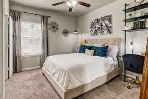 San Antonio apartment for rent - A bedroom with a large bed and a ceiling fan.