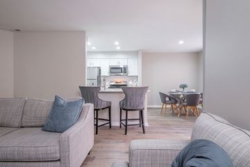 Gahanna apartment for rent - a living room with a couch and a table with chairs