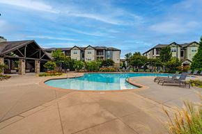 Smyrna apartment for rent - A swimming pool surrounded by lounge chairs and apartment buildings.