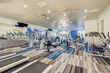 Aubrey apartment for rent - A gym with treadmills, stationary bikes, and other exercise equipment.