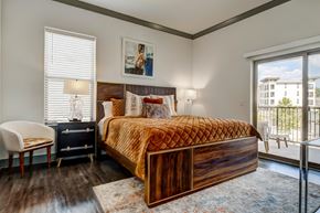 San Antonio apartment for rent - A bedroom with a large bed and a chair.
