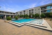 San Antonio apartment for rent - A large swimming pool in front of a building.