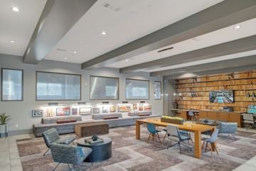 San Antonio apartment for rent - A modern living room with a long bookshelf filled with books.