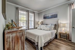San Antonio apartment for rent - A bedroom with a large bed and a wooden chest.