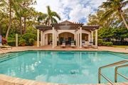 Jupiter apartment for rent - A pool with a building in the background.