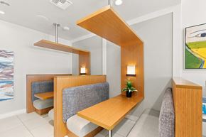 Miami apartment for rent - A modern dining area with a wooden table and grey chairs.