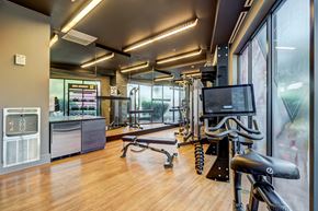 Washington apartment for rent - A gym with a variety of equipment including a treadmill, a stationary bike, and a rowing machine.