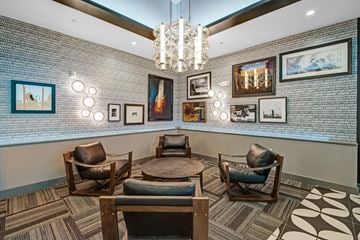 Houston apartment for rent - A living room with a grey couch and a chandelier.