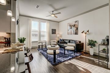Rowlett apartment for rent - A modern living room with a dining table and chairs.