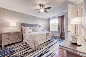 Lakeway apartment for rent - A bedroom with a large bed and a ceiling fan.