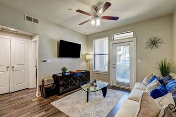 Austin apartment for rent - A living room with a brown coffee table and a white couch.