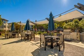 Humble apartment for rent - A sunny day at an outdoor dining area with tables and chairs.