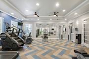 Fairfield apartment for rent - A spacious gym with a variety of equipment and a patterned carpet.